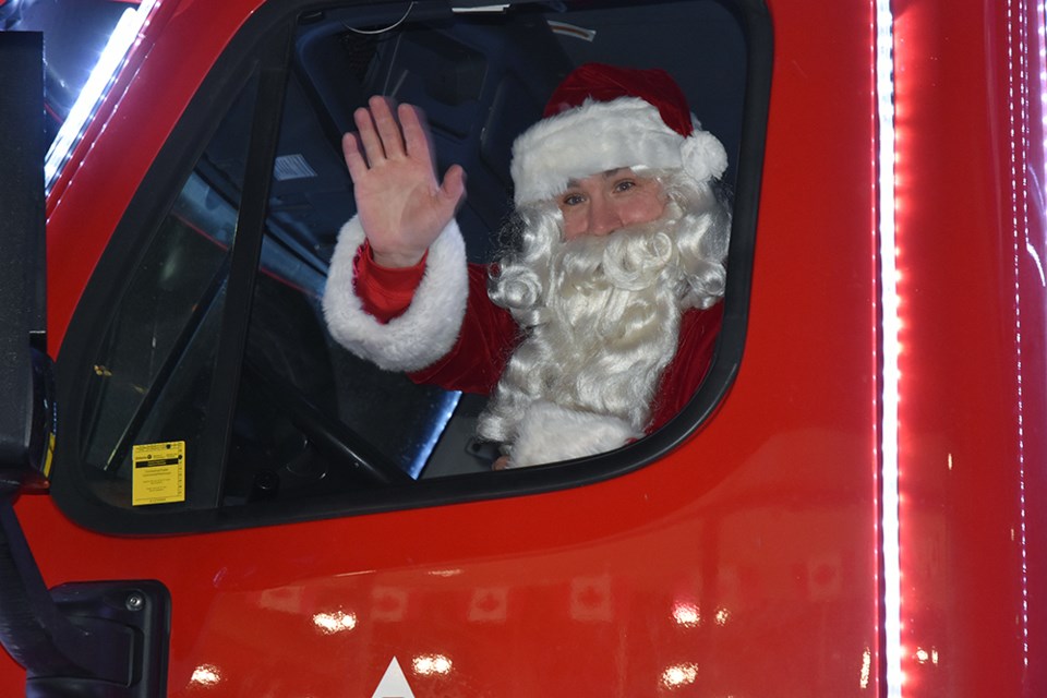 Santa at the wheel, of the Coca-Cola Canada Bottling Holiday Truck.