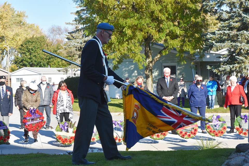 Denis Mainville, Lefroy-Belle Ewart Legion, lowers his flag during The Last Post, at a ceremony at Sandycove Acres.