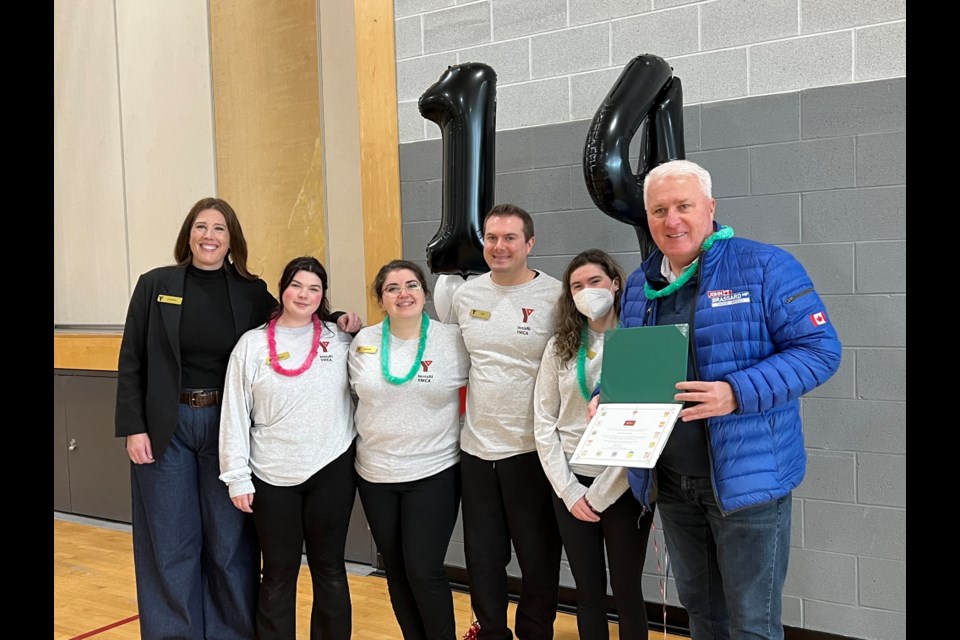 Member of Parliament for the riding of Barrie-Innisfil, John Brassard (far right), presents Cynthya Dahan (far left) and Innisfil YMCA's wonderful staff with a signed certificate recognizing the Innisfil YMCA's 14th anniversary. 