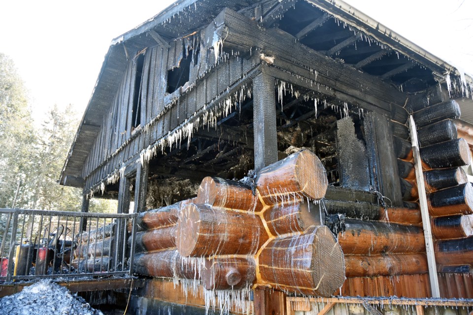 Rear of Alcona log home, ravaged by fire.