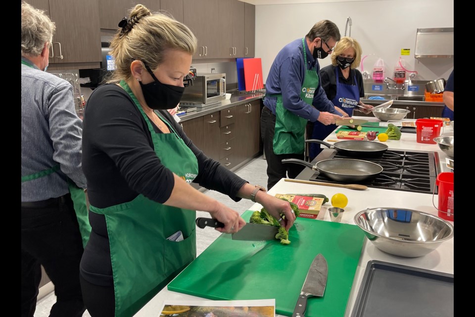 Mayor Lynn Dollin and members of Council take a cooking class, in the Horodynsky Community Kitchen.