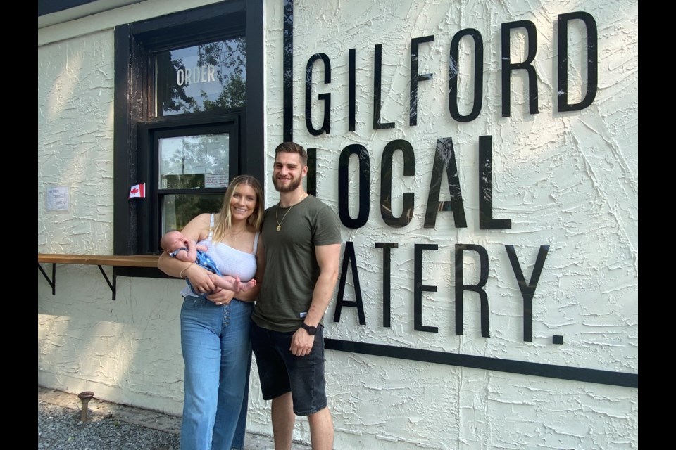 Anthony and Sadie with their new daughter Rooney in front of their new restaurant Gilford Local Eatery. 
