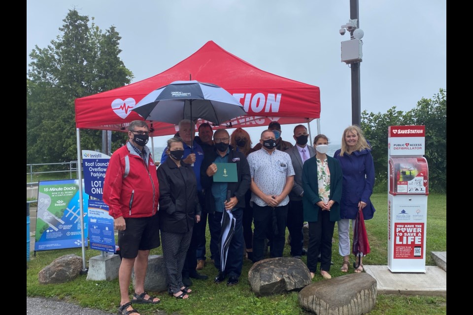 Members of Council and the Action First Aid Group along with co-sponsors Peggy Hill and Nick L'Ecuyer were at Innisfil Beach Park on Wednesday morning for the unveiling of the new AED SaveStation Tower. 