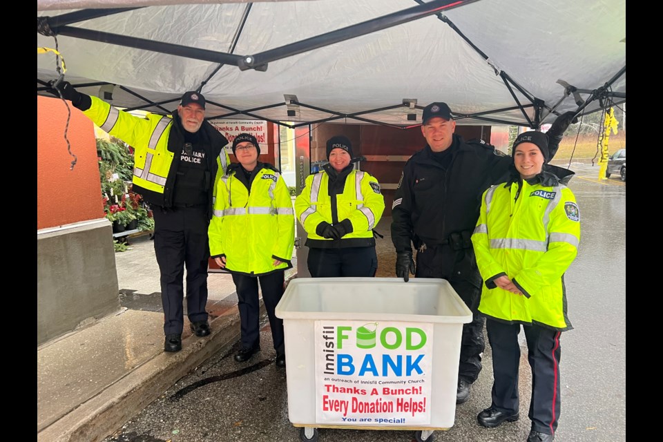 Members of the South Simcoe Police Service outside of Sobeys in Alcona on Saturday, December 3, 2022.