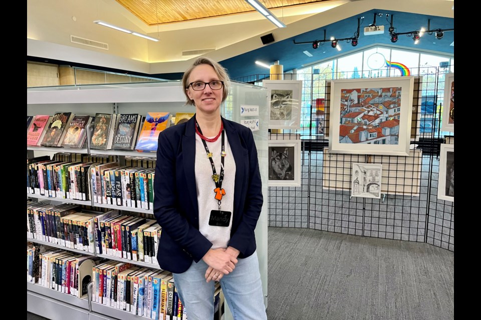 More than just books: Mandy Pethick, manager of library services and collection services with the Innisfil ideaLAB & Library, is shown with the works of local artists.