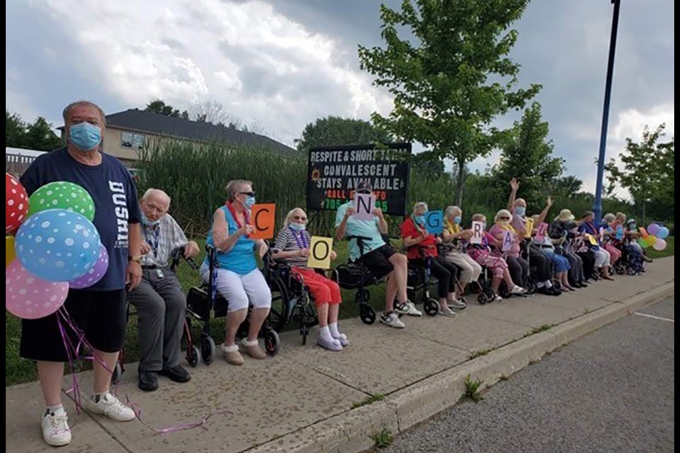 Senior residents of Lakeside sitting out along Innisfil Beach Road to applaud the Nantyr Shores Secondary School students participating in the Nantyr Graduation Parade on June 29