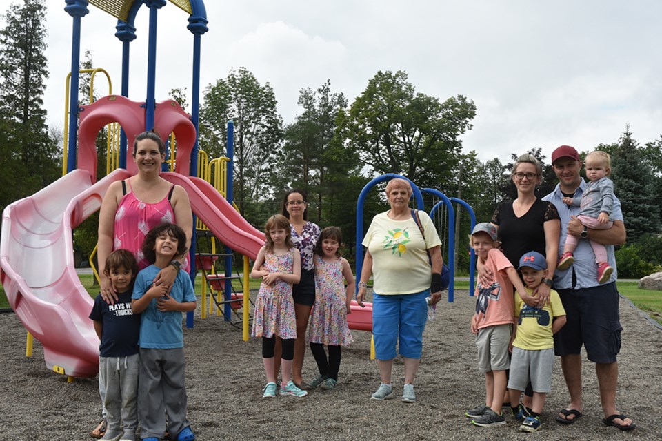 From left, Alexxa Abi-Jaoude with two-and-a-half-year-old Nicholas and five-year-old Patrick; Sarah Webb with Betsy, 9, and Nora, 6; Flo Allen; and Patty Chambers-Kane and Mark Kane with their three children, in a favourite playground that they seldom get to visit – due to the dangers of crossing busy roads.