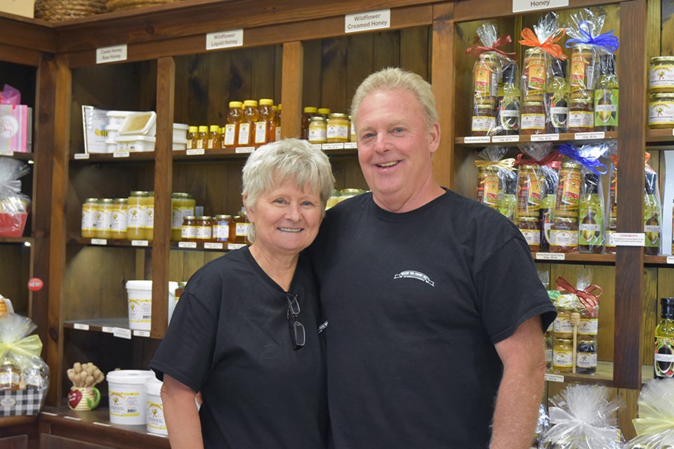 Peter and Sandi Dickey, standing in the Dickey Bee Honey retail store, retire at the end of the month.