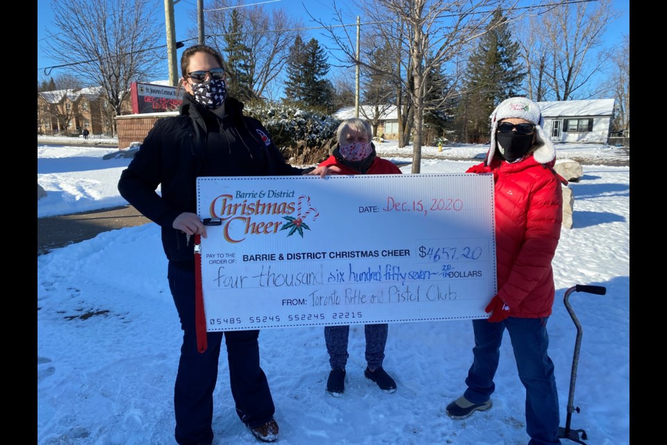 Meghan Bilton (left) VP of Operations and one of the founders of the Toronto International Rifle & Pistol Club donates a cheque to the Barrie & District Christmas Cheer Organization. (Right) Diane Gayler and Cindy Tonn (President of Barrie Christmas Cheer). 
