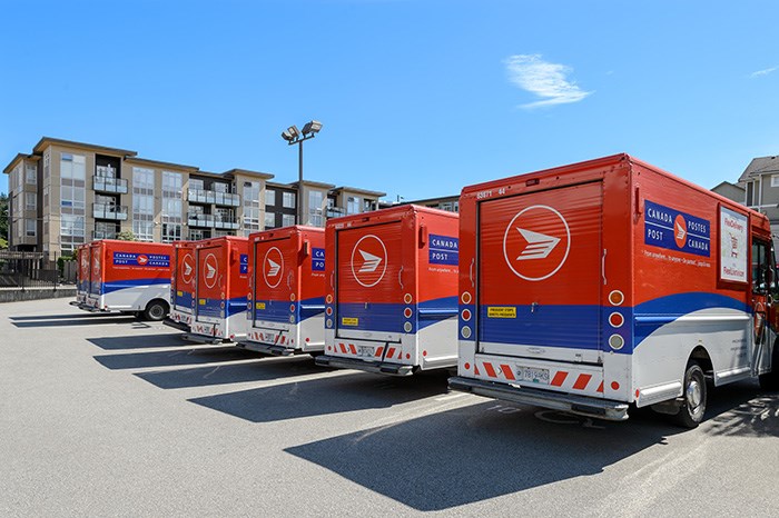 Canada Post delivery trucks. (via Shutterstock)