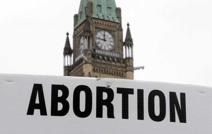 Pro-life supporters hold anti-abortion signs as they take part in the March For Life rally on Parliament Hill in Ottawa in this Canadian Press file photo.