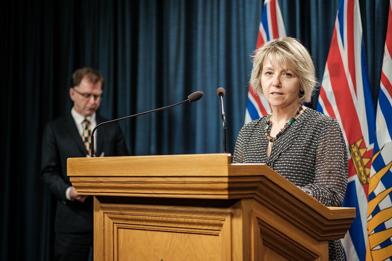 Dr. Bonnie Henry in the foreground and Health Minister Adrian Dix in the background