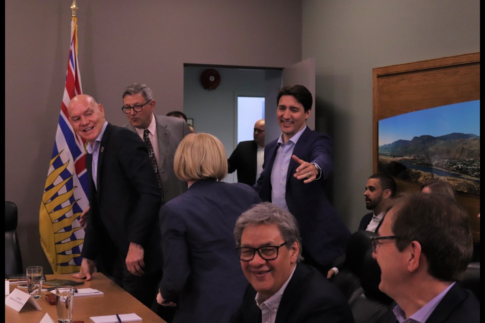 Prime Minister Justin Trudeau (centre right) greets Carla Qualtrough (centre front), Minister of Public Services and Procurement and Accessibility, while Conrad Sauvé (far left), president of the Canadian Red Cross and Kamloops Mayor Ken Christian (left) meet. (via Brendan Kergin)