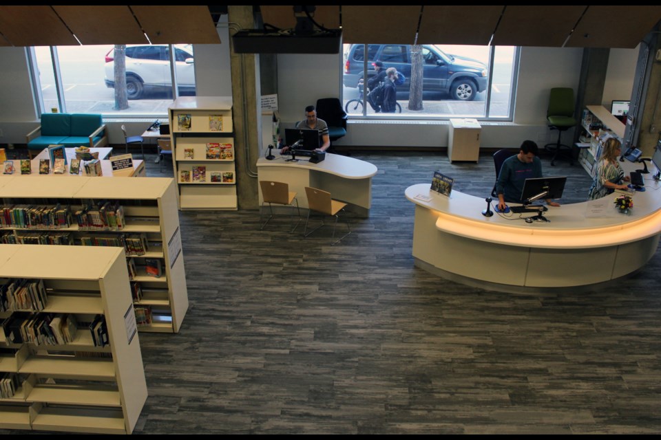 The library's entrance is more open and features the check-out desk facing people walking in, so staff can greet them. (via Brendan Kergin)