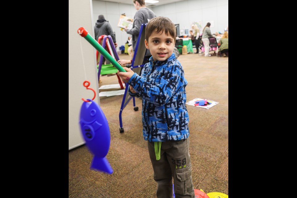 Five-year-old Gideon Costillo hooks a fish on his line, in a fun literacy game during the ABC Family Literacy Day at the Henry Grube Education Centre in North Kamloops.