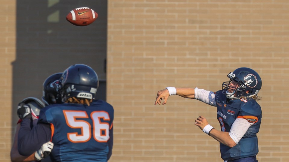 1 Reid Vankoughnett (1) scrambling out of the pocket & throwing a completed pass on the run_1067 FEAT