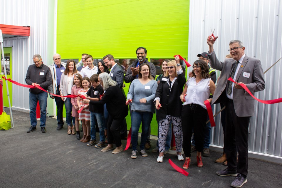 On May 12, Kamloops Mayor Ken Christian (far right) joined food bank executive director Bernadette Siracky (second from right) in 
cutting the ribbon to officially open the facility.
