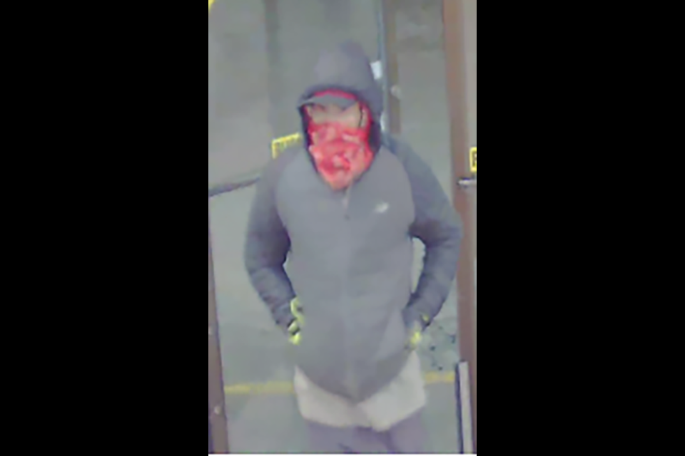 The suspect stands about 5-foot-5 and has a medium build and a gruff voice. At the time, he was wearing a full red face mask, a black hoodie, black pants and gloves with distinct fluorescent yellow marks on them.