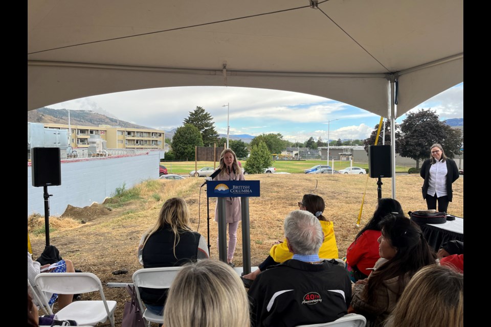 Dayna Chapman (at the podium during the Aug. 4, 20022, groundbreaking of Katherine's Place) previously lived in foster care with Katherine McParland and worked with her on blueprints for the project now underway.

