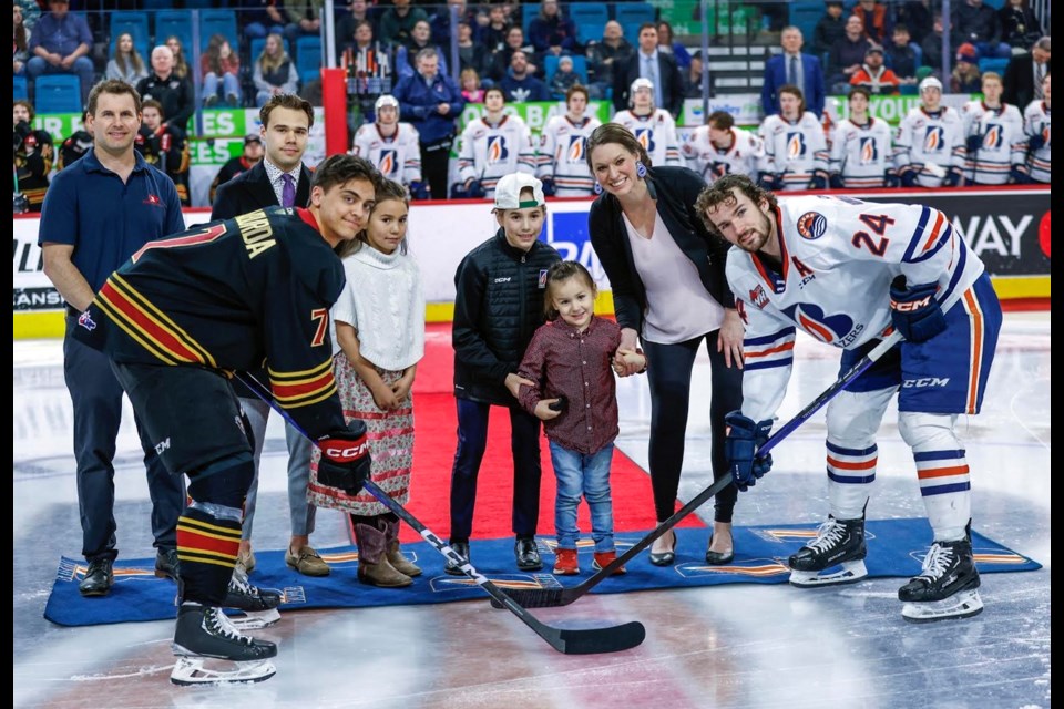 Riel Antoine (centre) gets set to drop the puck for a ceremonial faceoff on March 11 between Kamloops Blazer Ethan Brandwood (right) and Vancouver Giant Ty Halaburda. With Riel were mom Bonnie and siblings Sequoia and Maya. Far left Hockey Gives blood co-founder Stu Middleton and Blazer captain Logan Stankoven.
