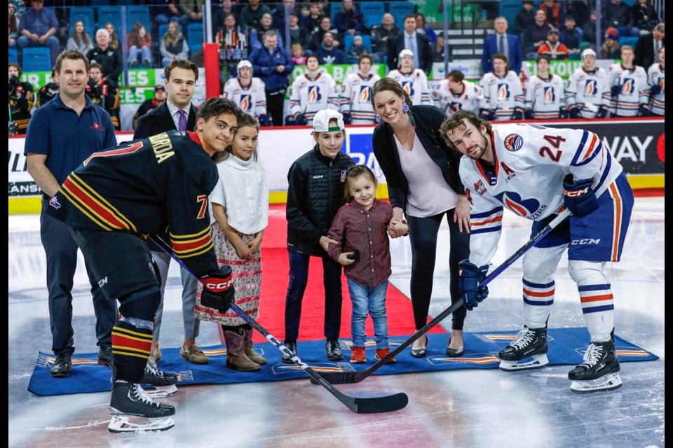 Riel Antoine (centre) gets set to drop the puck for a ceremonial faceoff on March 11 between Kamloops Blazer Ethan Brandwood (right) and Vancouver Giant Ty Halaburda. With Riel were mom Bonnie and siblings Sequoia and Maya. Far left Hockey Gives blood co-founder Stu Middleton and Blazer captain Logan Stankoven.
