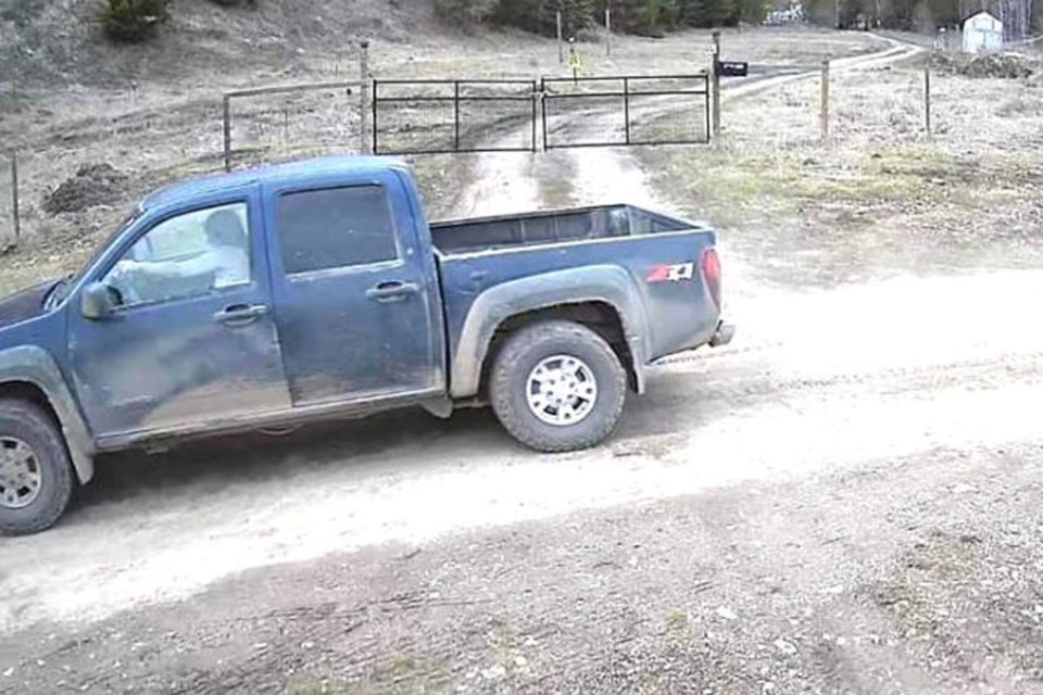 A blue pickup truck driven by a woman is captured on camera on April 8, 2022, following a suspicious fire near Westwold.
