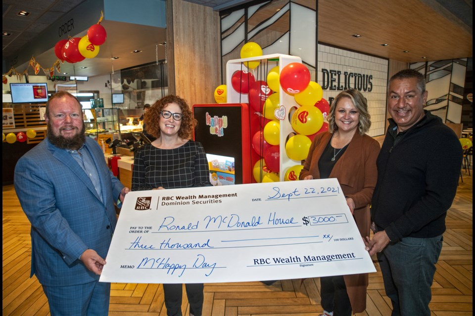 Criterion Capital Group of RBC Dominion Securities, vice-president and branch director of RBC Securitiies, Mike Edwards (left) and Criterion Capital Group associate investment advisor, Sarah Cuzzetto  present a cheque for $3,000 to Brandy Gozda-Sekhon, owner of Aberdeen, Walmart and Merritt McDonald's stores, and her husband Sonny Sekhon on Wednesday. The donation added to the funds raised during McHappy Day, and will go toward the Ronald McDonald House to be built in Kamloops in the new patient-care tower at Royal Inland Hospital.