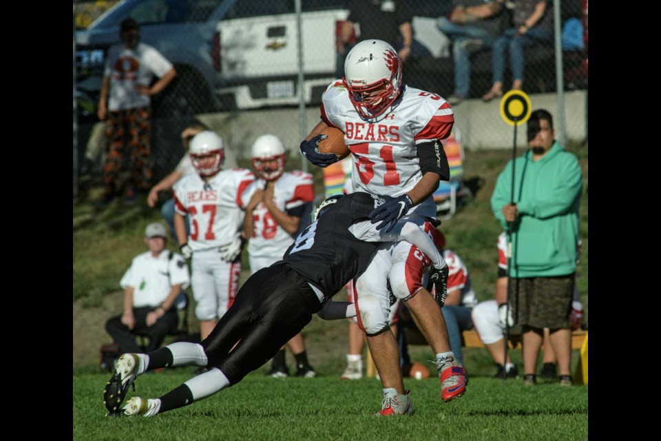 Charlie Peters of the South Kamloops Titans tackles Levi Radautu of Mt. Boucherie on Thursday at South Kamloops secondary.