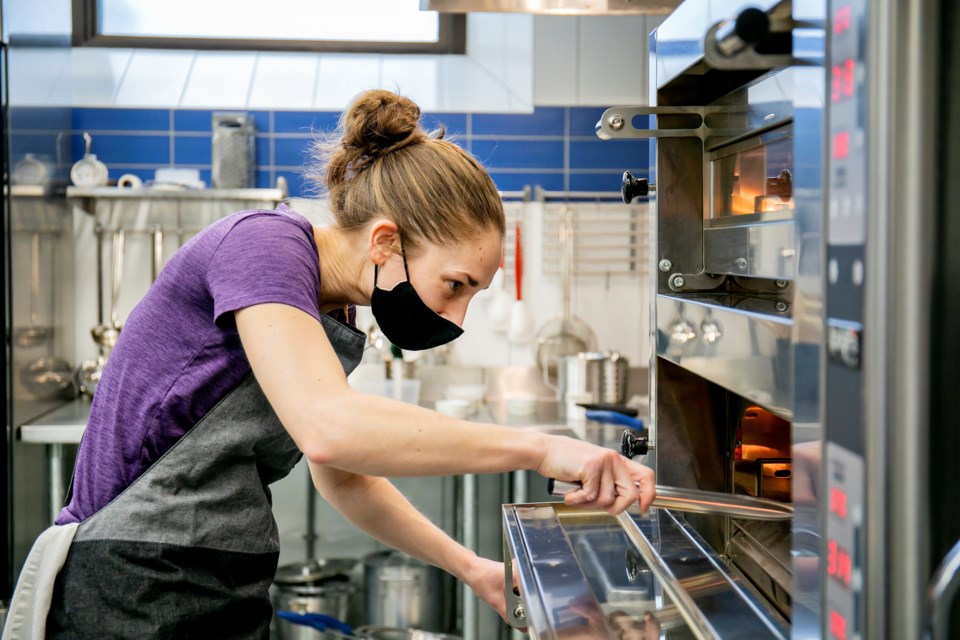 Tiny Home Takeout head Chef Amy Cyr working in the kitchen 