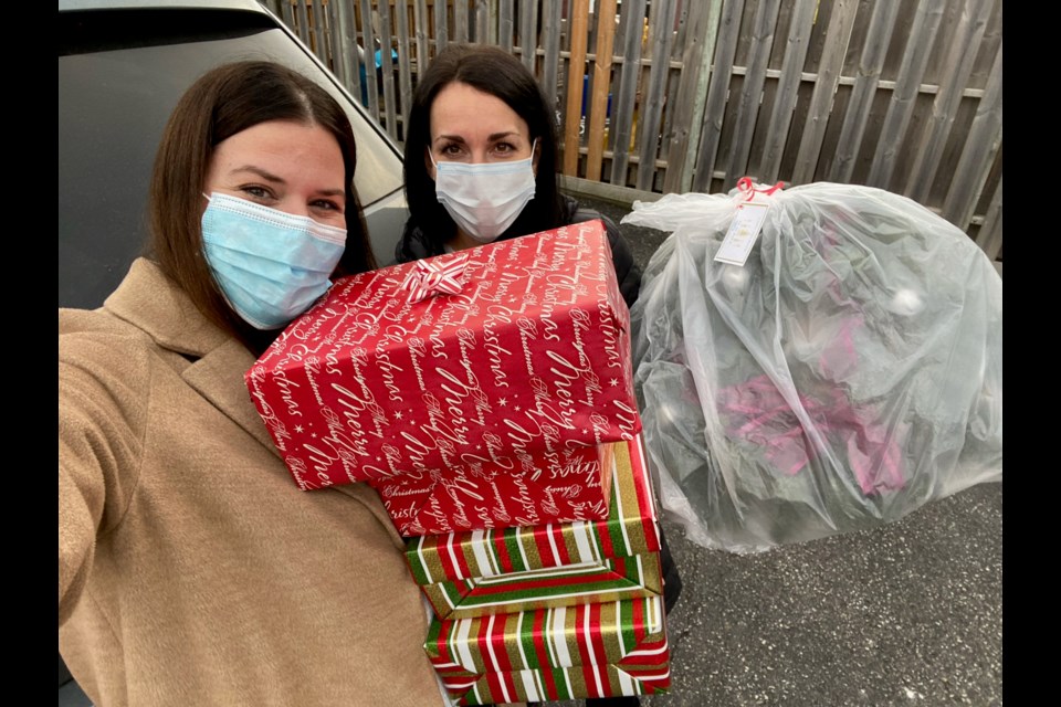Gillian Kilpatrick and Cat McGuire deliver gifts and wreaths to a long-term care home