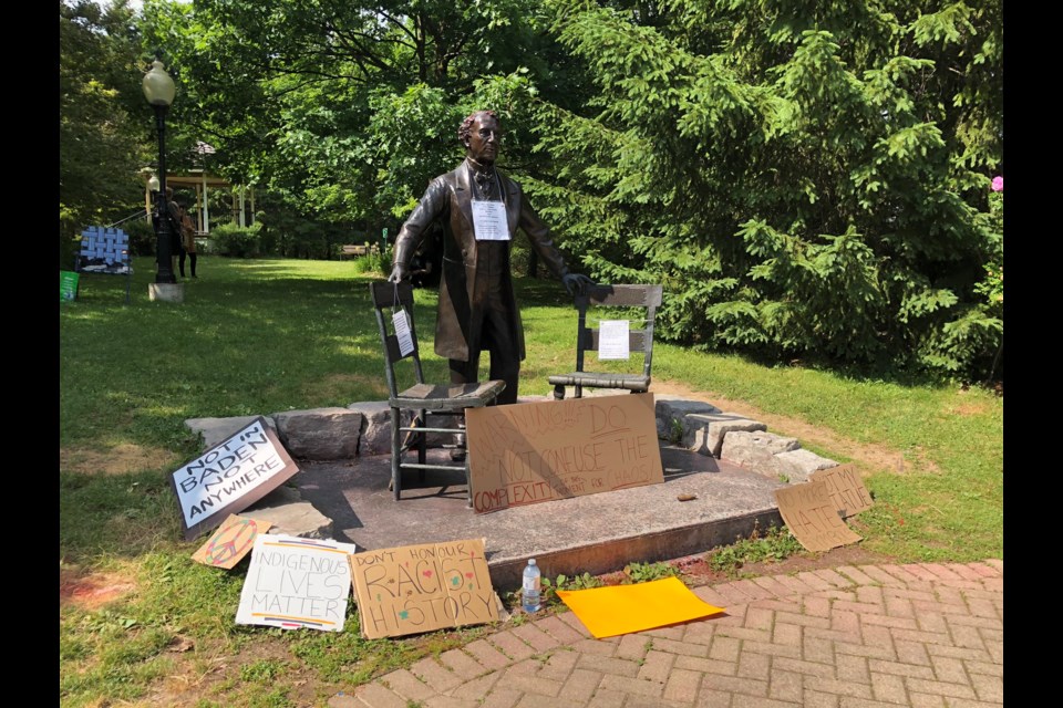 The statue of Sir John A. MacDonald, surrounded by signs placed by participants in the sit-in. Phi Doan/KitchenerToday