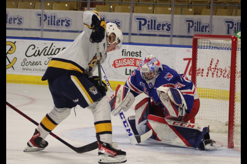 Kitchener's Pavel Cajan makes one of his 47 saves in regulation and overtime to help the Rangers salvage a point.