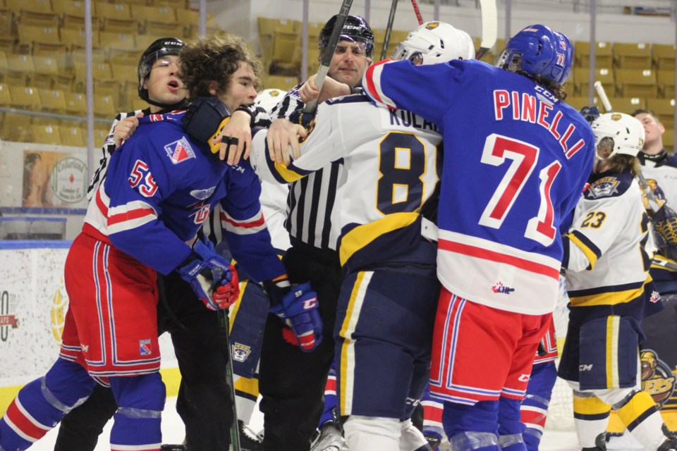 Kitchener's Mitchell Martin and Francesco Pinelli scrum with Erie's Artyom Kulakov after a whistle.