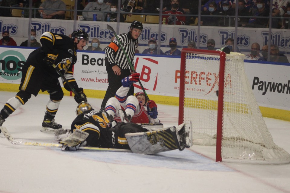 Kitchener Rangers forward Reid Valade falls to his back as he scored his first of two goals against the Sarnia Sting.