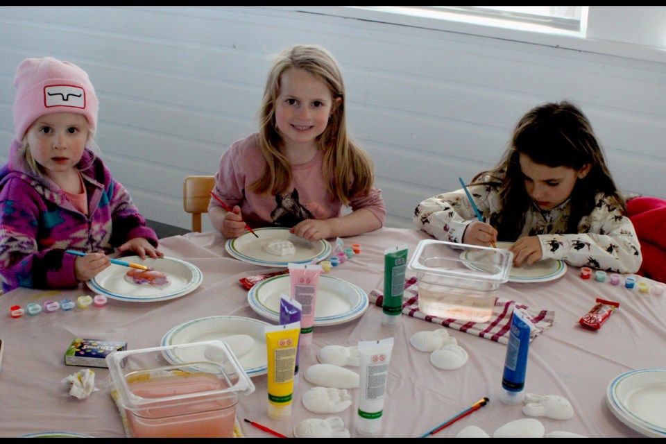 Della and Darla Rosychuk-Routhier and Paisley Rempel enjoy the egg painting activity that was on offer at the 2025 ‘Easter at the Mission’ event, which took place on the afternoon of April 19 at the Lac La Biche Mission. Chris McGarry photo. 