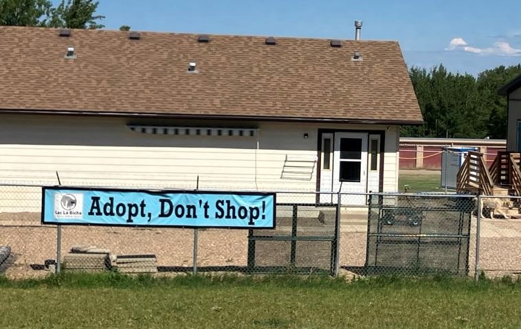The 'Adopt, Don't Shop' sign on the fence of the Lac La Biche Regional Humane Society. Chris McGarry photo.