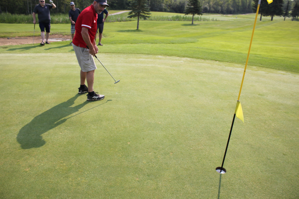 Al Robertson, who played on the team representing Portage College, puts away a birdie on the 18th hole. Chris McGarry photo.