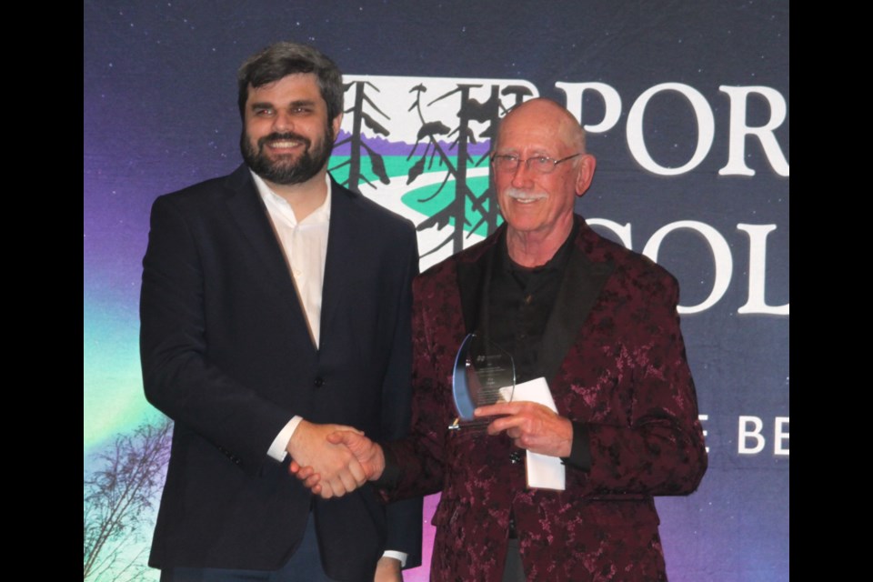 Ken Staples is presented with his award by Alex Fuller, communications coordinator for Lac La Biche County. Staples, an inductee into the 2024 Lac La Biche County Sports Hall of Fame, was awarded in both the athlete and community builder categories. Chris McGarry photo. 