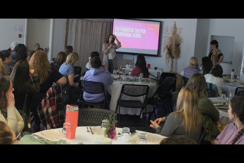 Allison Dupre, owner of Straight and Arrow Boutique in Plamondon, which put on 'The Power and Style of Perimenopause' in association with Hope Haven women's shelter in Lac La Biche, speaks with women gathered inside McArthur Place community hall prior to the event getting underway. Chris McGarry photo. 