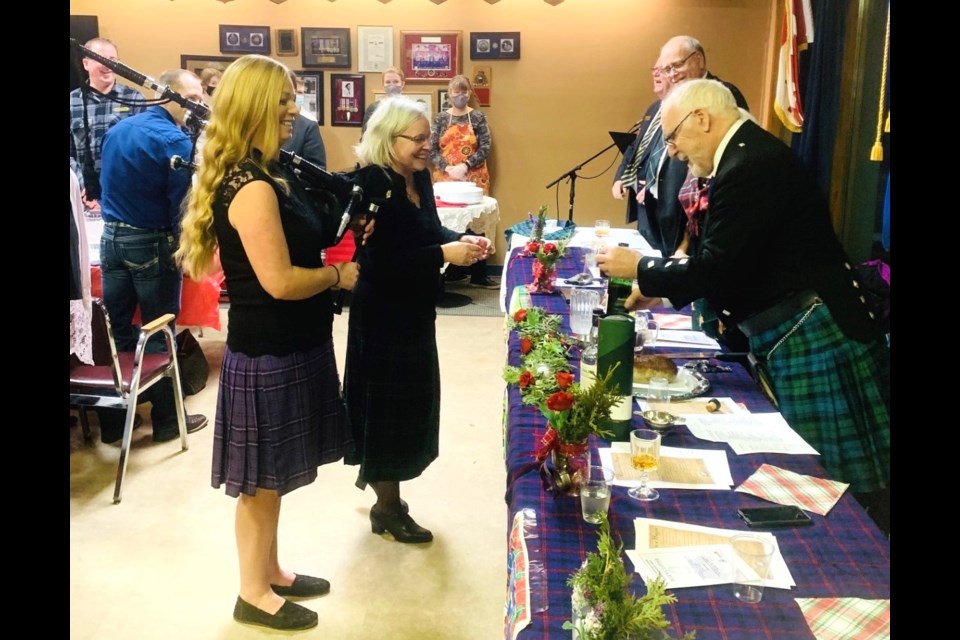 Molly Fyten (with bagpipes), Ruth Fyten, and Angus Campbell at a Robbie Burns celebration at the Lac La Biche Legion. 