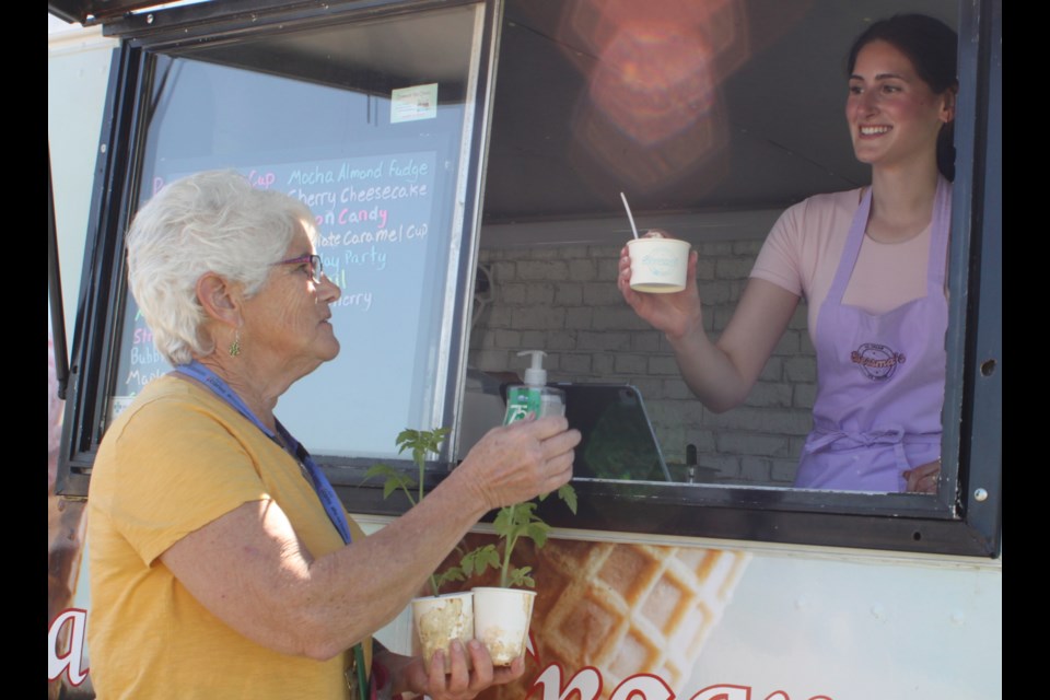 Bessma Tarrabain, owner of Bessma’s Ice Cream, serves up an ice cream cone to Anita Reid, a unit clerk in the emergency department of the William J. Cadzow Healthcare Centre on May 29 for an event put on by the Lac La Biche Regional and Retention Society (RARS). Healthcare workers in Lac La Biche were given free cones of ice cream for the event, which was done in conjunction with Alberta Rural Health Week, which ran from May 26-30. Chris McGarry photo.