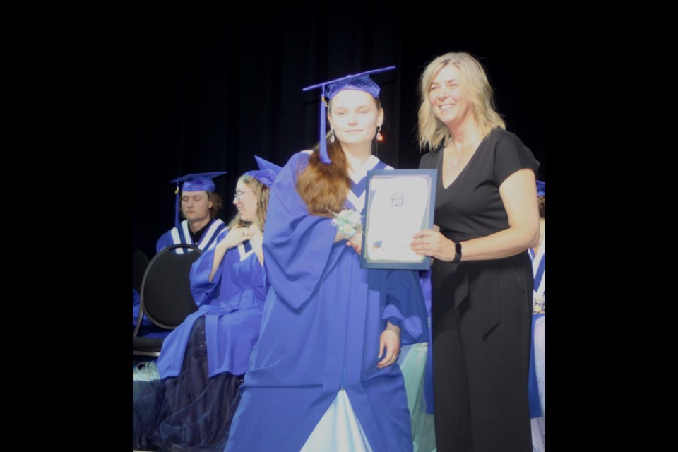 Apsia Anufriev-Reutov receives her graduation diploma from Ecole Plamondon Principal Karen Grygus. Chris McGarry photo.