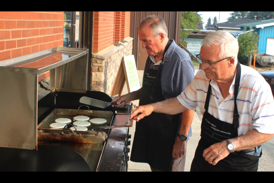 Aurel Langevin and Ovid Langevin were at the Lac La Biche Heritage Society bright and early on the morning of Aug. 1 flipping flapjacks for the 2025 Lac La Biche Pow Wow Days pancake breakfast. Chris McGarry photo.