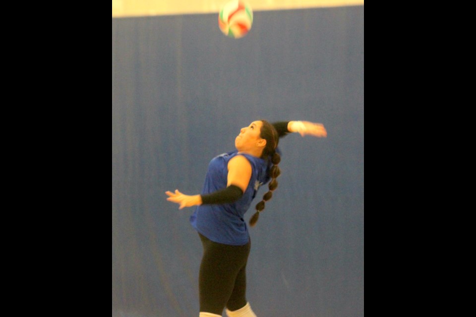Berry Rosychuk serves the volleyball. Chris McGarry photo.