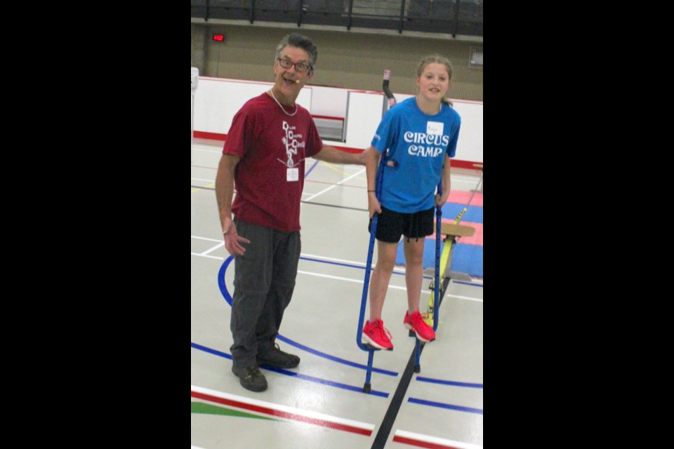 Bob Palmer (a.k.a. Flyin’ Bob) jokes around with Maya White as he teaches her the proper way to walk on stilts during Flyin’ Bob’s Circus Camp, which took place this past week at the Bold Center. Chris McGarry photo.
