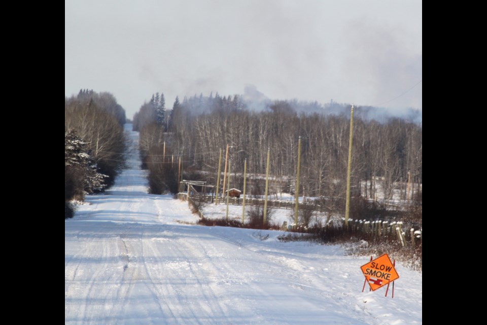 Signs notifying motorists of brush piles being burned nearby can be seen in different areas of the Lac La Biche region. Chris McGarry photo. 