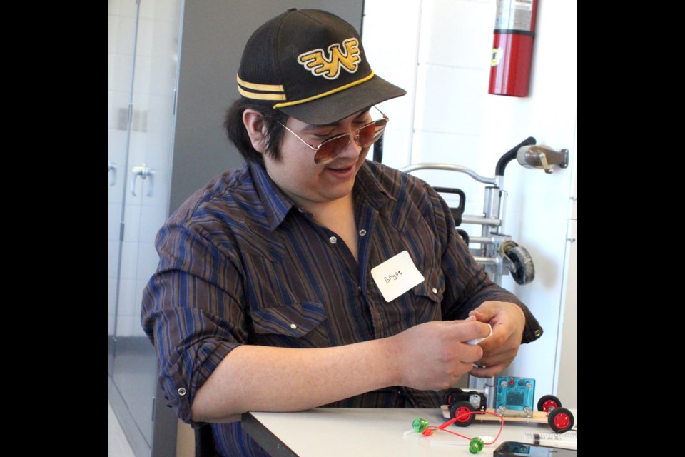 Bryce Delorme, a Grade 12 student at JA Williams (JAWS) High School in Lac La Biche, has fun as he goes about building a hydrogen fuel cell car during the Energy Innovation Day event that took place on Portage College on April 9. Students from JAWS and Ecole Plamondon participated in the educational workshops and presentations. Chris McGarry photo. 