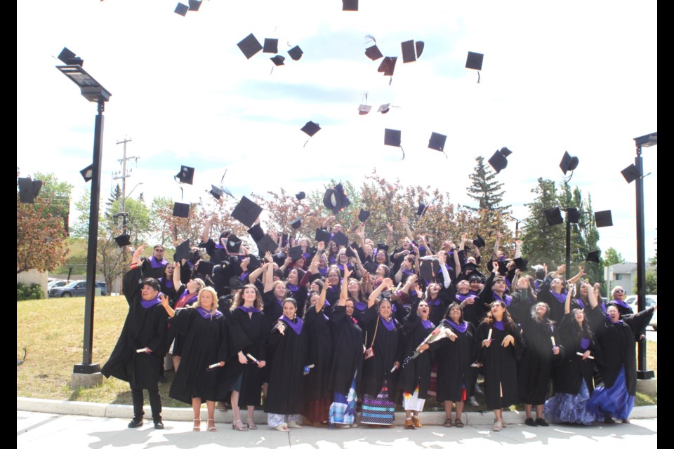 Graduates celebrate with the traditional cap-tossing ceremony. Chris McGarry photo.