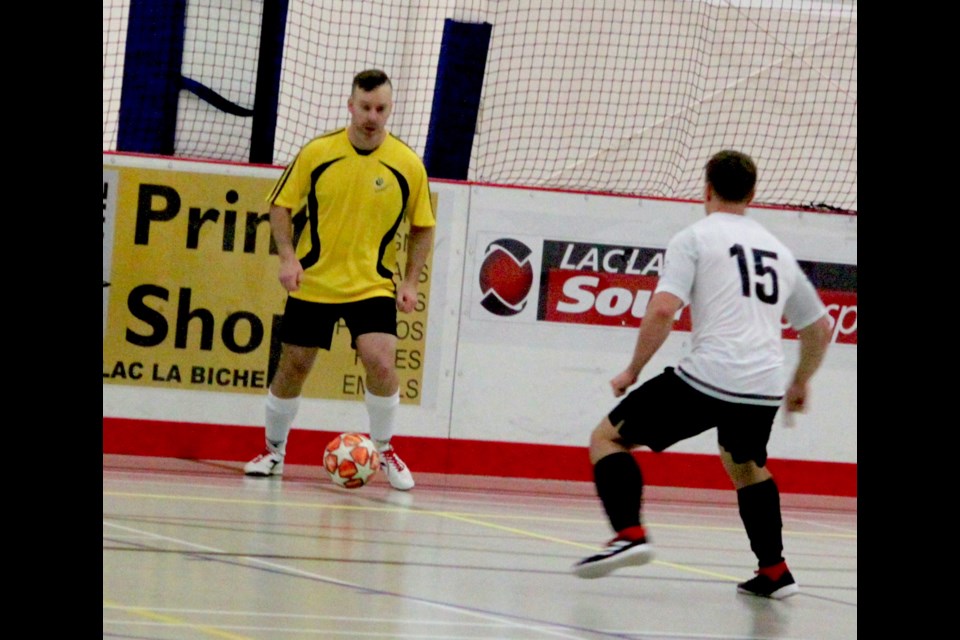 Carson Tosczak of the Lac La Biche Team is confronted by Athabasca player Ryan Schaub as he prepares to take the ball back out onto the indoor at the Bold Centre. Chris McGarry photo.
