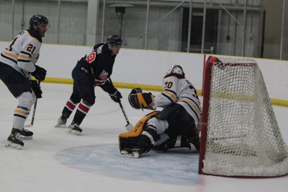 Concordia University of Edmonton Thunder goalie Griffin Bowerman leaps into action to stop the puck as Portage College Voyageurs forward attacks his net during Saturday’s game at the Bold Centre. Chris McGarry photo. 